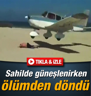Uçak kumsalda güneşlenen adamın sırtına iniyordu